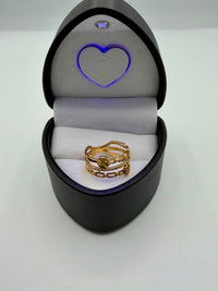 14k This is a stack of yellow gold rings, including a chain link ring, a diamond eternity band, and a ring featuring a screw-head motif. With Cz diamonds