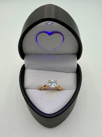 14k This is a yellow gold three-stone engagement ring featuring a cushion-cut center stone and pear-cut side stones, possibly made with cubic zirconia.