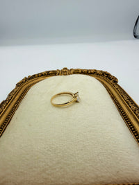 14k This is a 14K yellow gold heart-shaped solitaire engagement ring with a (Cz) center stone.