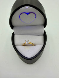 This is a 14k yellow gold princess cut solitaire engagement ring With (Cz) stone