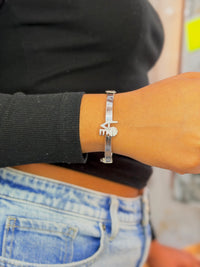 silver bangle bracelet features a diamond-accented "LOVE"