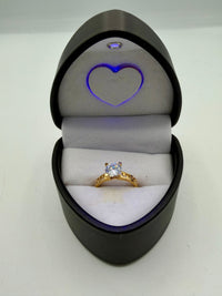 14k yellow gold engagement ring featuring a round cubic zirconia (CZ) solitaire stone and a Greek key design band.