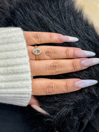 This is a 14k yellow gold oval aquamarine and halo ring by BB